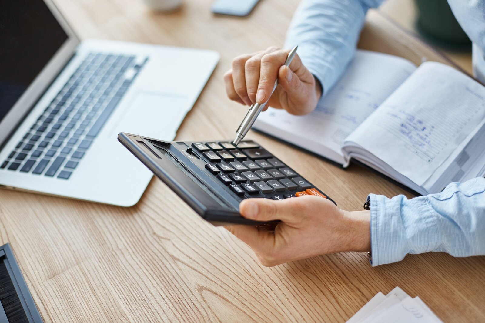 cropped-view-professional-serious-finance-manager-holding-calculator-hands-checking-company-month-s-profits.jpg