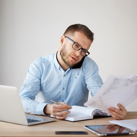 busy-concentrated-businessman-glasses-shirt-sitting-comfortable-office.jpg